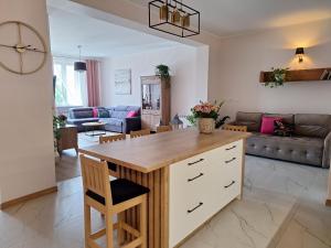 a kitchen and living room with a large island at Apartament przy Jeziorku Magistrackim in Mrągowo
