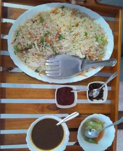 a table with a plate of rice and a bowl of sauce at Sadew Villa in Anuradhapura