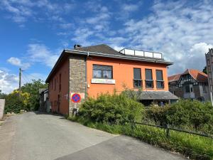 an orange building on the side of a road at Race & Rooms in Francorchamps