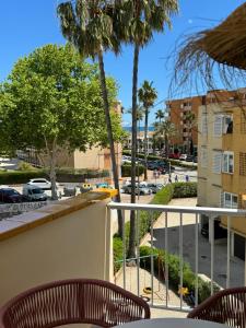 a balcony with chairs and a view of a street at Playa del Ter in Platja de l'Arenal