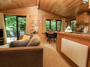 a living room with a couch and a table at Derwent Lodge in Keswick +27 photos
