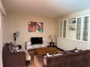 a living room with two couches and a coffee table at Dodo Casita House in Tamarin