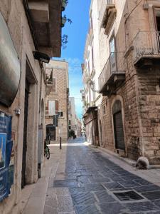 an empty street in an alley with buildings at CASA NiNì in Trani +21 photos
