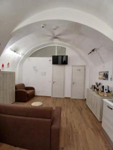 a living room with a couch and a tv at CASA NiNì in Trani