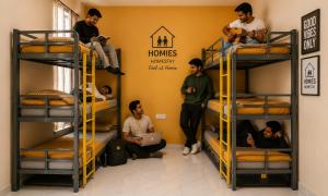 a group of people in a room with bunk beds at Homies Homestay Boys Hostel in Kurukshetra