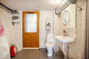 a bathroom with a toilet and a sink at Cozy summer apartment in Archipelago in Öckerö +23 photos