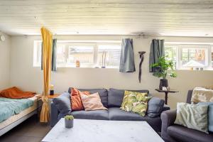 a living room with a couch and a table at Cozy summer apartment in Archipelago in Öckerö