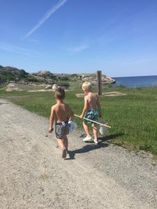 two young boys walking down a gravel road at Cozy summer apartment in Archipelago in Öckerö