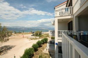 a view of the beach from the balcony of a house at Apartments Vujic in Mirce