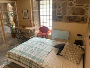 a bedroom with a bed and a desk and a chair at Casa dos Carballos in Covelo +63 photos