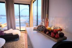 a kitchen counter with a cutting board with fruit on it at Solvesborg Houseboat with Harbour Views - Sleeps 4 in Sölvesborg