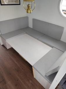 a white bed in a room next to a wall at Solvesborg Houseboat with Harbour Views - Sleeps 4 in Sölvesborg