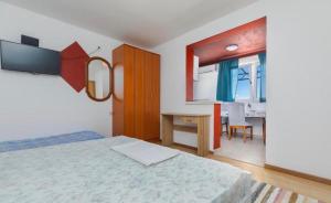 a bedroom with a bed and a desk in it at Miljak in Duće