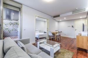 a living room with a couch and a table at The Corporate Residence & Parking in Madrid