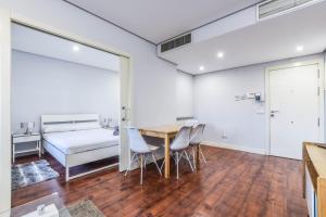 a bedroom with a bed and a table and chairs at The Corporate Residence & Parking in Madrid