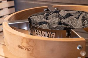 a wooden bowl filled with gray rocks in a wooden box at Äkäsentie 1 A 211 by Holiday in Lapland in Äkäslompolo
