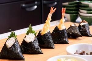 a group of sushi rolls on a cutting board at Richmond Hotel Nagoya Shinkansen-guchi in Nagoya
