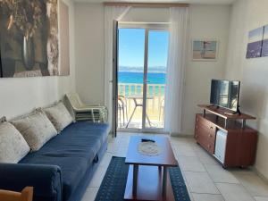 a living room with a couch and a view of the ocean at Apartments Vujic in Mirce