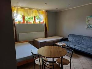 a living room with a couch and a table and chairs at ivlo in Pszczyna
