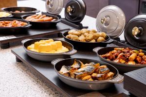 a buffet with many different types of food in bowls at Richmond Hotel Nagoya Shinkansen-guchi in Nagoya +40 photos