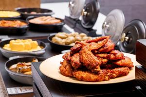 a plate of fried food on a table with other foods at Richmond Hotel Nagoya Shinkansen-guchi in Nagoya