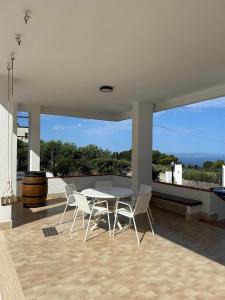 a patio with a table and chairs on a roof at Villa Silvia in Erice