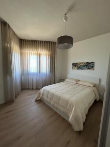 a bedroom with a large bed and a large window at Villa Silvia in Erice +25 photos