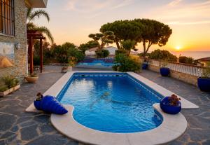 a swimming pool with blue inflatables in a backyard at VILLA MIRAMAR in Peniscola