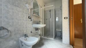a bathroom with a sink and a toilet and a shower at Casteluce Hotel Funivie in Pinzolo +158 photos