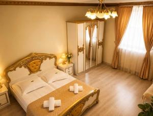 a bedroom with a bed and a table with two crosses on it at Pensiunea Cardinal in Sibiu