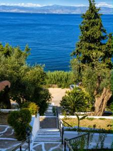 a stairway leading down to a beach with the ocean at Aether seaview in Benitses
