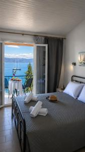 a bedroom with a large bed with a view of the ocean at Aether seaview in Benitses