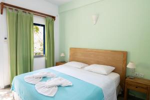 a bedroom with a bed with towels on it at Ikion Studios in Steni Vala Alonissos