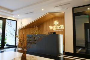 a lobby of a store with a sign on the wall at Indigen Riverside Hotel Cao Bang in Cao Bằng