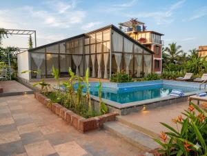 a house with a swimming pool next to a building at CP Villa Resort in Bhāweghar