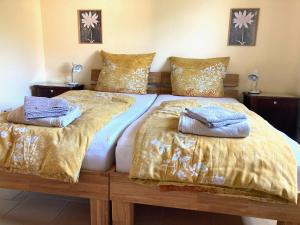 a large bed with two pillows on top of it at Burgblick Pünderich in Pünderich