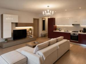 a living room with a couch and a kitchen at HERASTRAU APARTMENTS 3 camere self check-in in Bucharest