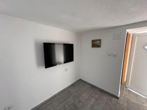 a room with a flat screen tv on the wall at Vikendica za odmor in Kloštar Ivanić