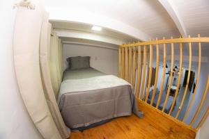 a small bedroom with a bed next to a staircase at Loft Misiones 226 in Puerto Iguazú