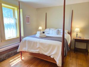 a bedroom with a large bed with white sheets and pillows at The Cortina Inn in Donegal