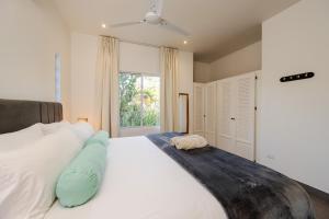 a bedroom with a large bed and a window at Pazifico Villas in Playa Avellana +113 photos
