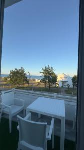 a table and chairs on a balcony with a view of the ocean at Astara Villa Boutique Hotel in Astara