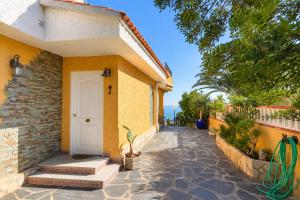 a house with a white door and a walkway at VILLA MIRAMAR in Peniscola
