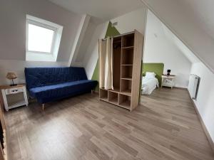 a living room with a blue couch in a room at Maison campagne in Champ-du-Boult