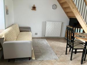 a living room with a couch and a table at Maison campagne in Champ-du-Boult
