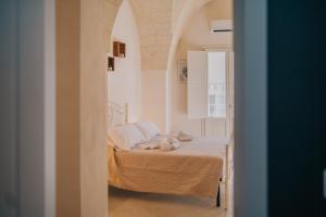 a bedroom with a bed with a teddy bear on it at La Dimora del Vicolo - Apartment in Francavilla Fontana