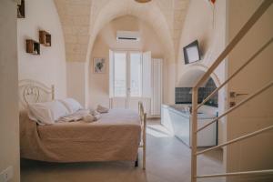 a bedroom with a bed and a tub and a sink at La Dimora del Vicolo - Apartment in Francavilla Fontana