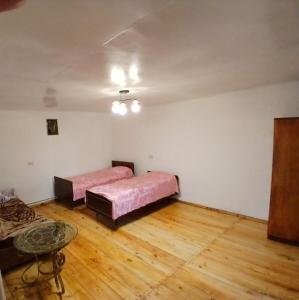 a room with two beds and a table in it at Vardeni Guest house in Dsegh