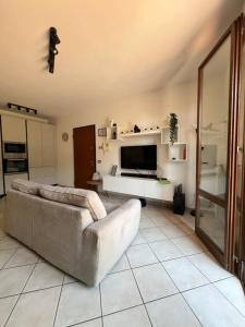 a living room with a couch and a television at Ponsy Dream - Firenze, Pisa, Livorno in Ponsacco +4 photos