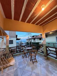 a patio with chairs and a table on a balcony at Casa Maré in Aracati